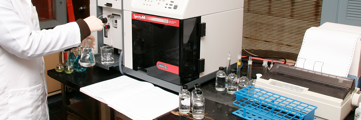 A scientist analyzes a sample using Atomic Absorption spectroscopy