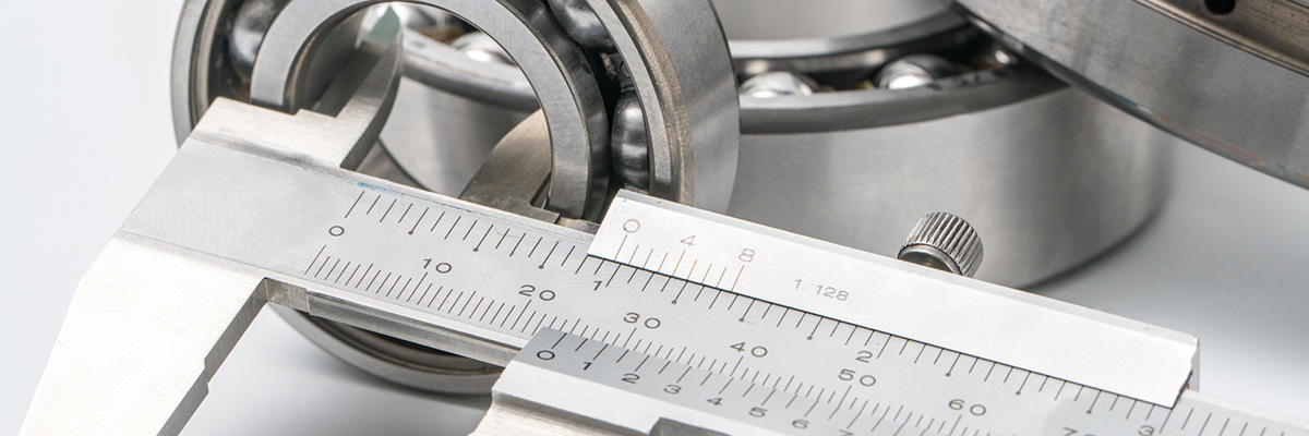 Using calipers to measure a component